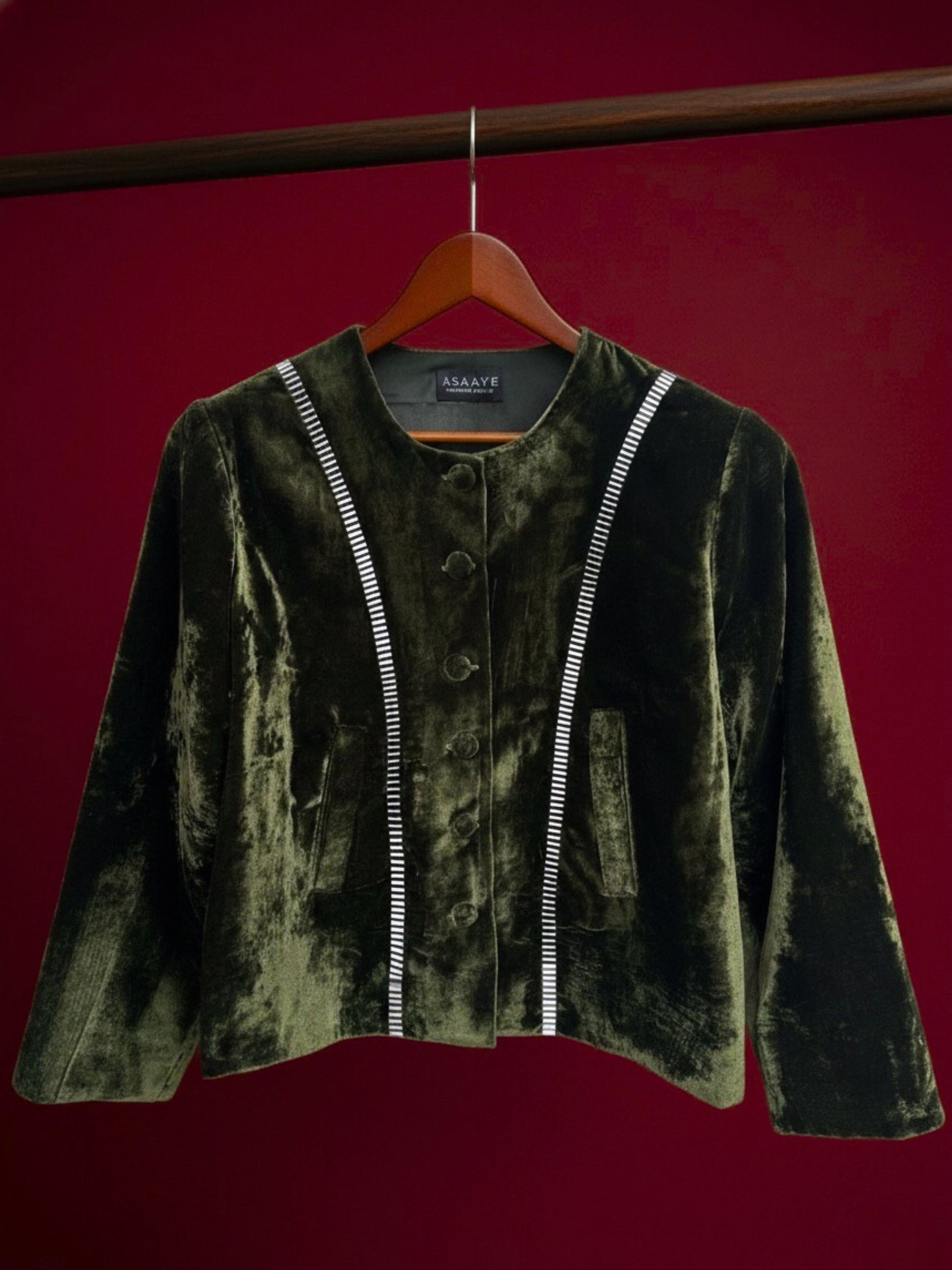 Green velvet short jacket for women with metallic 3D silver signature detailing on front, collarless design by Asaaye